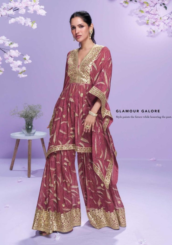 Woman wearing a maroon and gold traditional outfit with cherry blossoms in the background