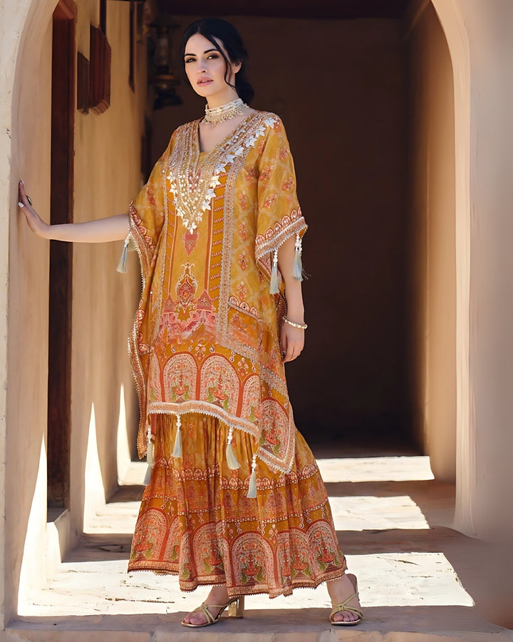 Woman wearing a mustard yellow embroidered kaftan kurta with sharara pants and tassel details – festive outfit for Mehendi, Diwali, Teej and Haldi in UAE by Meraki Vastram.