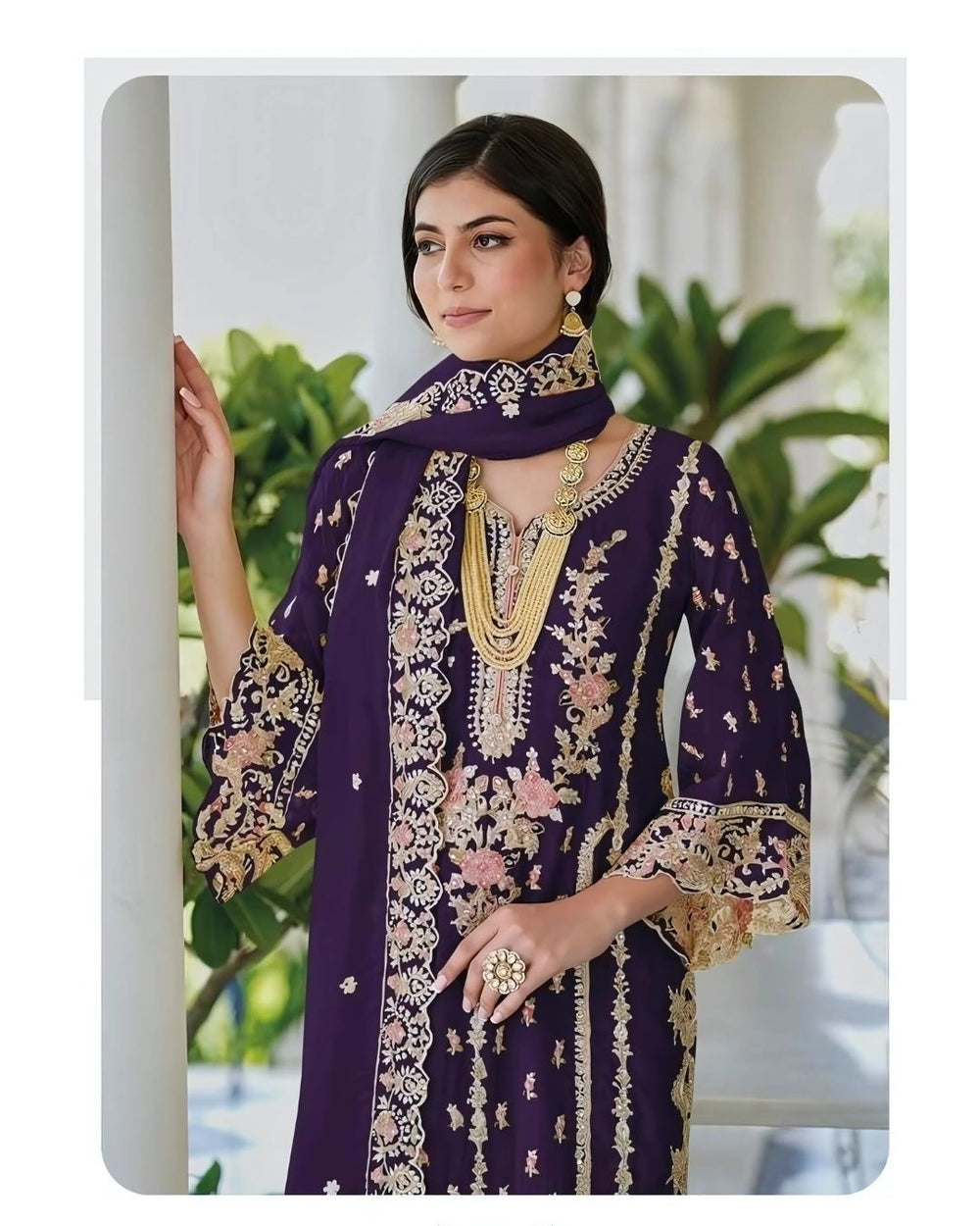 Woman wearing a deep plum embroidered straight-cut suit with floral detailing and matching dupatta, ideal for Diwali, weddings, and festive wear – Meraki Vastram UAE ethnic collection.