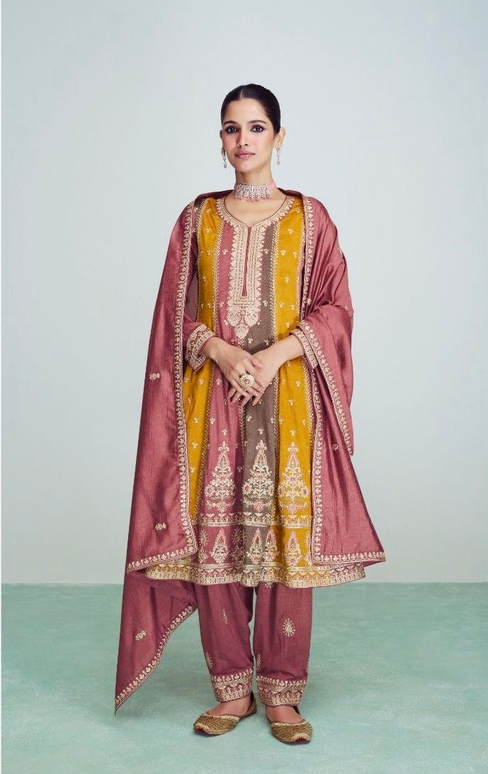 Woman wearing a mustard and mauve straight-cut embroidered suit with matching pants and dupatta, ideal for festive and wedding occasions like Diwali, Teej, Rakhi – Meraki Vastram ethnic wear UAE.