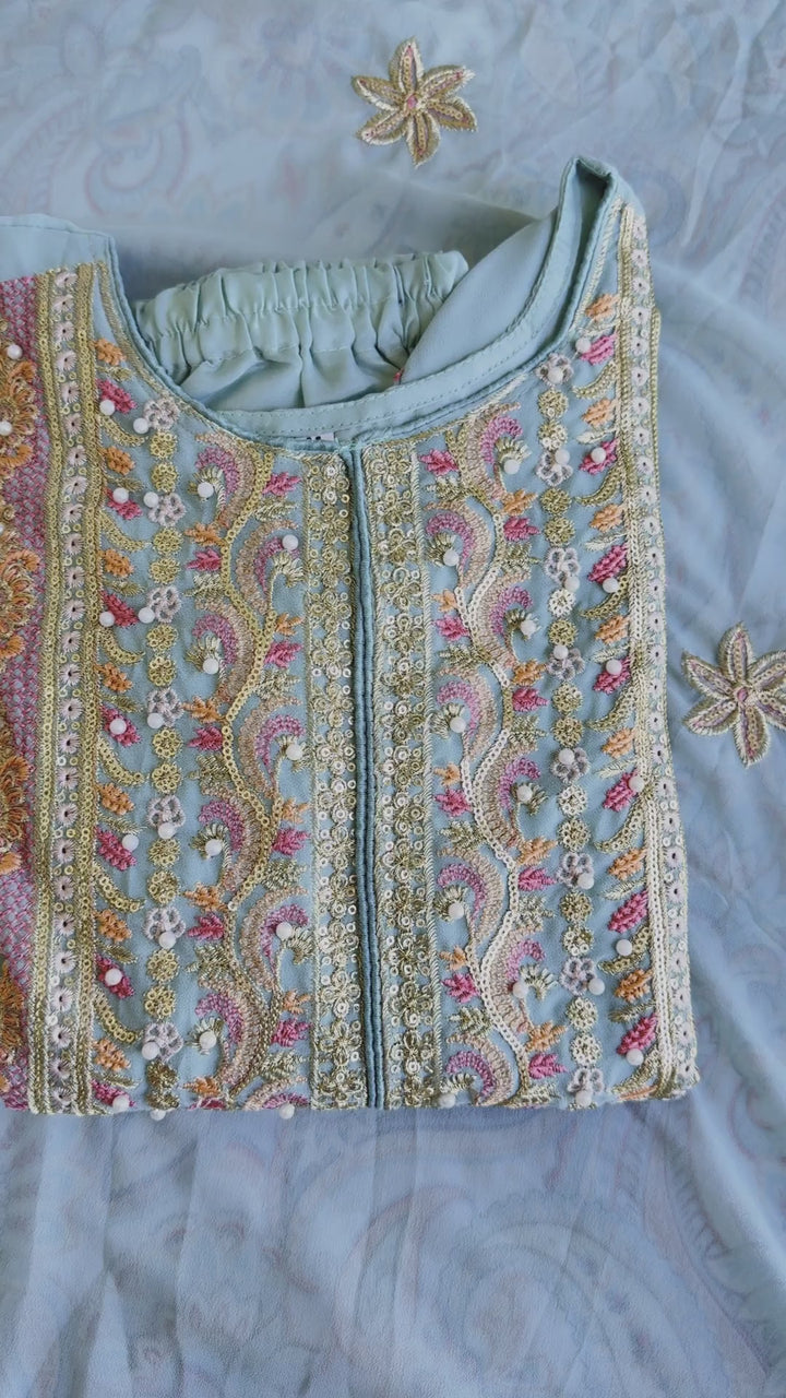 Woman wearing a powder blue pastel pakistani pret embroidered suit set with straight pants and dupatta – perfect for Eid, Rakhi, and festive daywear in UAE by Meraki Vastram.