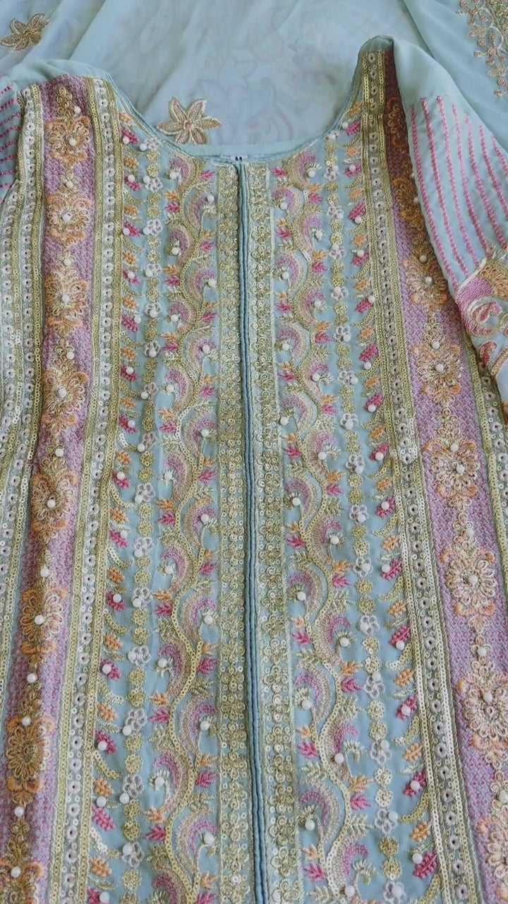 Woman wearing a powder blue pastel pakistani pret embroidered suit set with straight pants and dupatta – perfect for Eid, Rakhi, and festive daywear in UAE by Meraki Vastram.