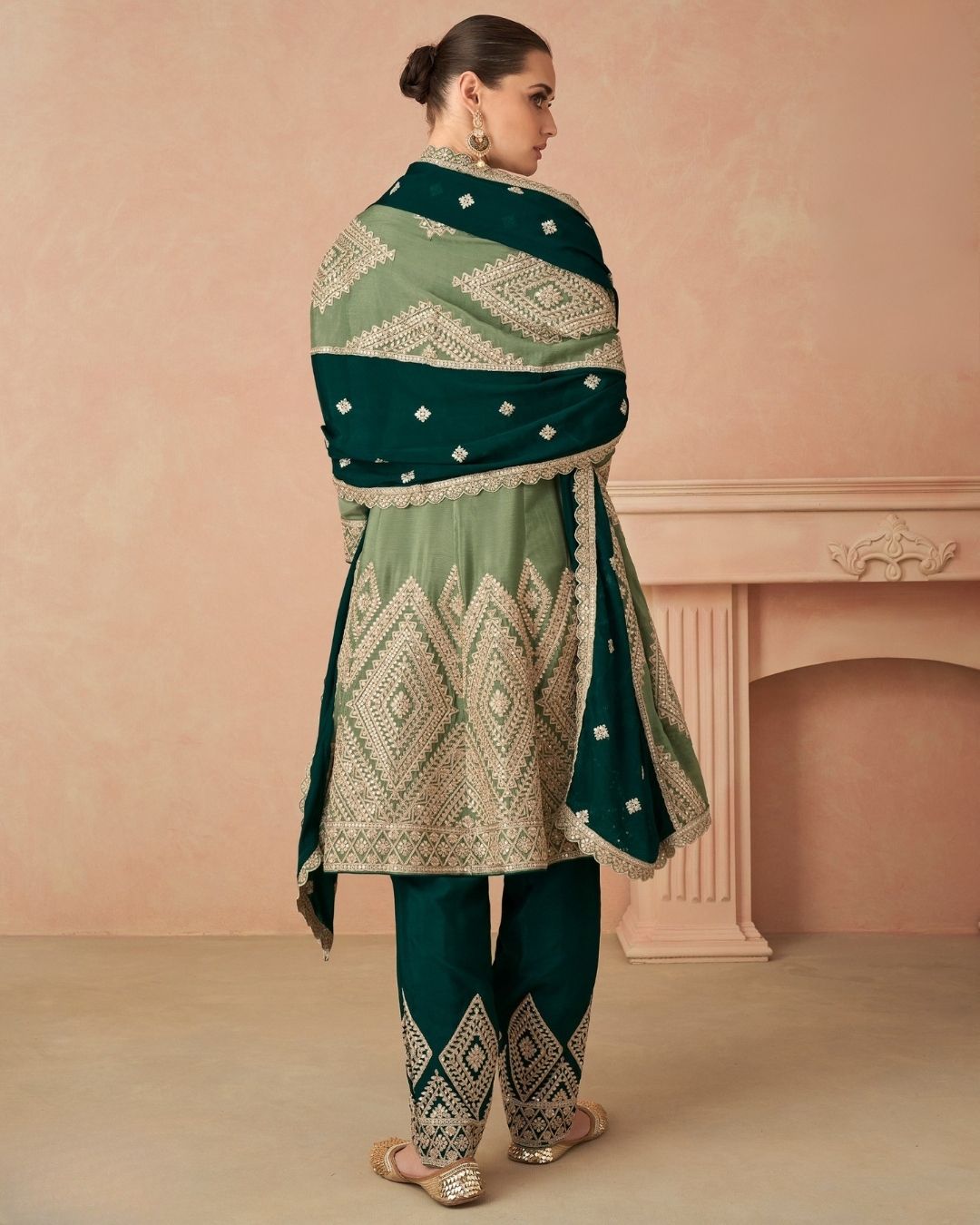 Woman wearing sage green embroidered A-line kurta with tapered pants and dupatta – elegant festive outfit for Diwali, Karwachauth, and mehendi events in UAE by Meraki Vastram.