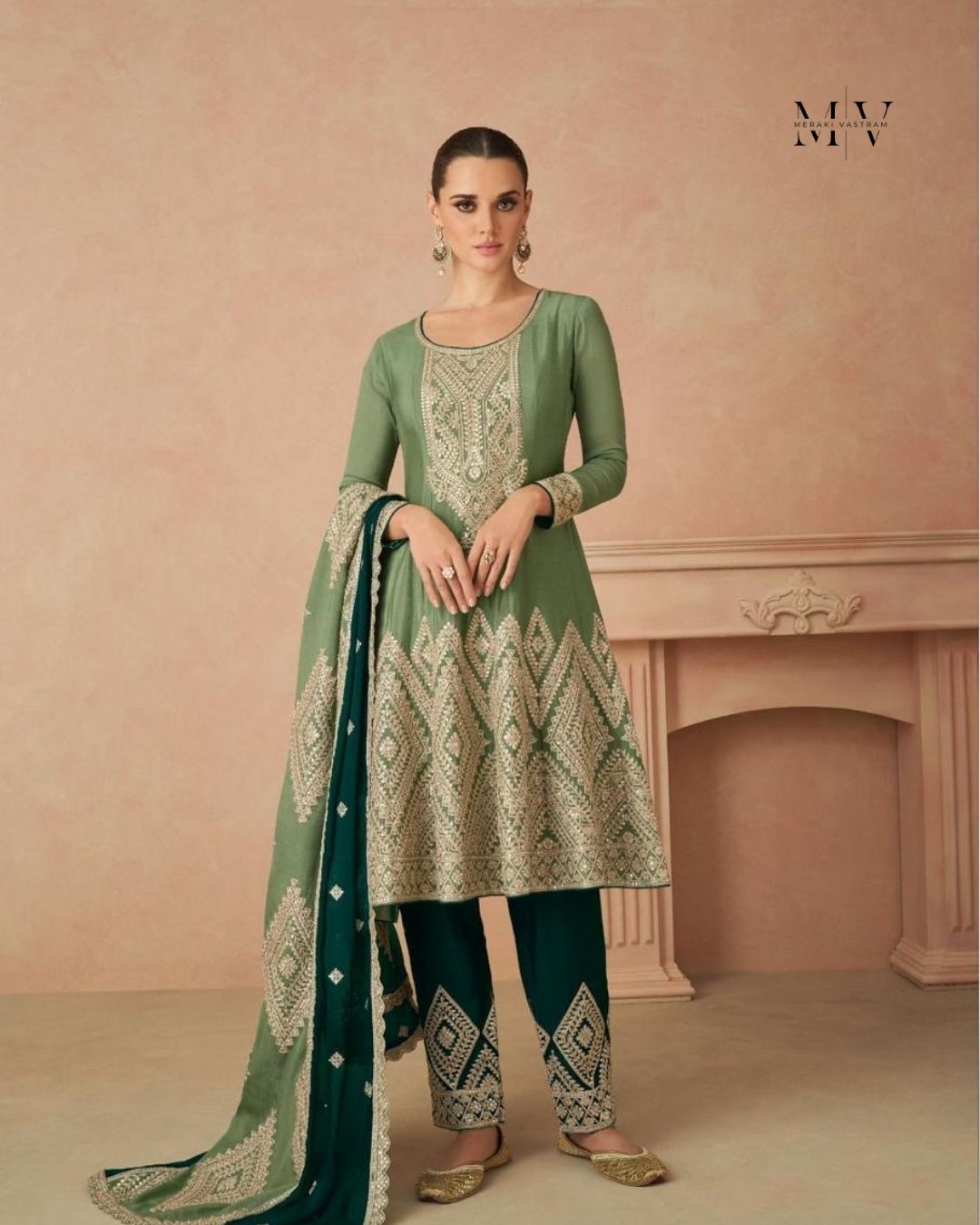 Woman wearing sage green embroidered A-line kurta with tapered pants and dupatta – elegant festive outfit for Diwali, Karwachauth, and mehendi events in UAE by Meraki Vastram.